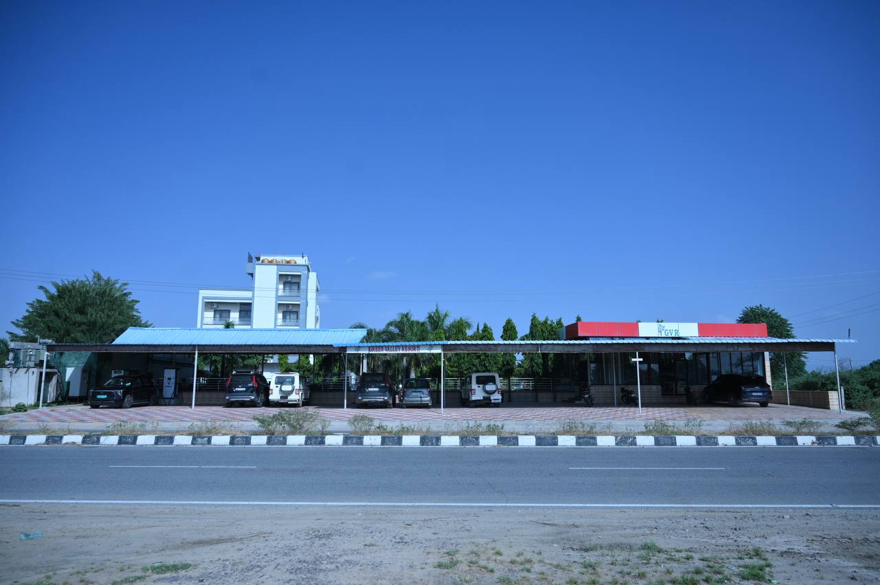 Road-facing resort frontage with covered parking and the hotel building behind it.